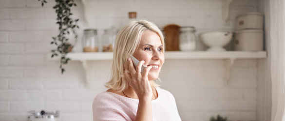 Middle aged woman on phone smiling
