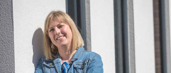 lady in denim jacket smiling