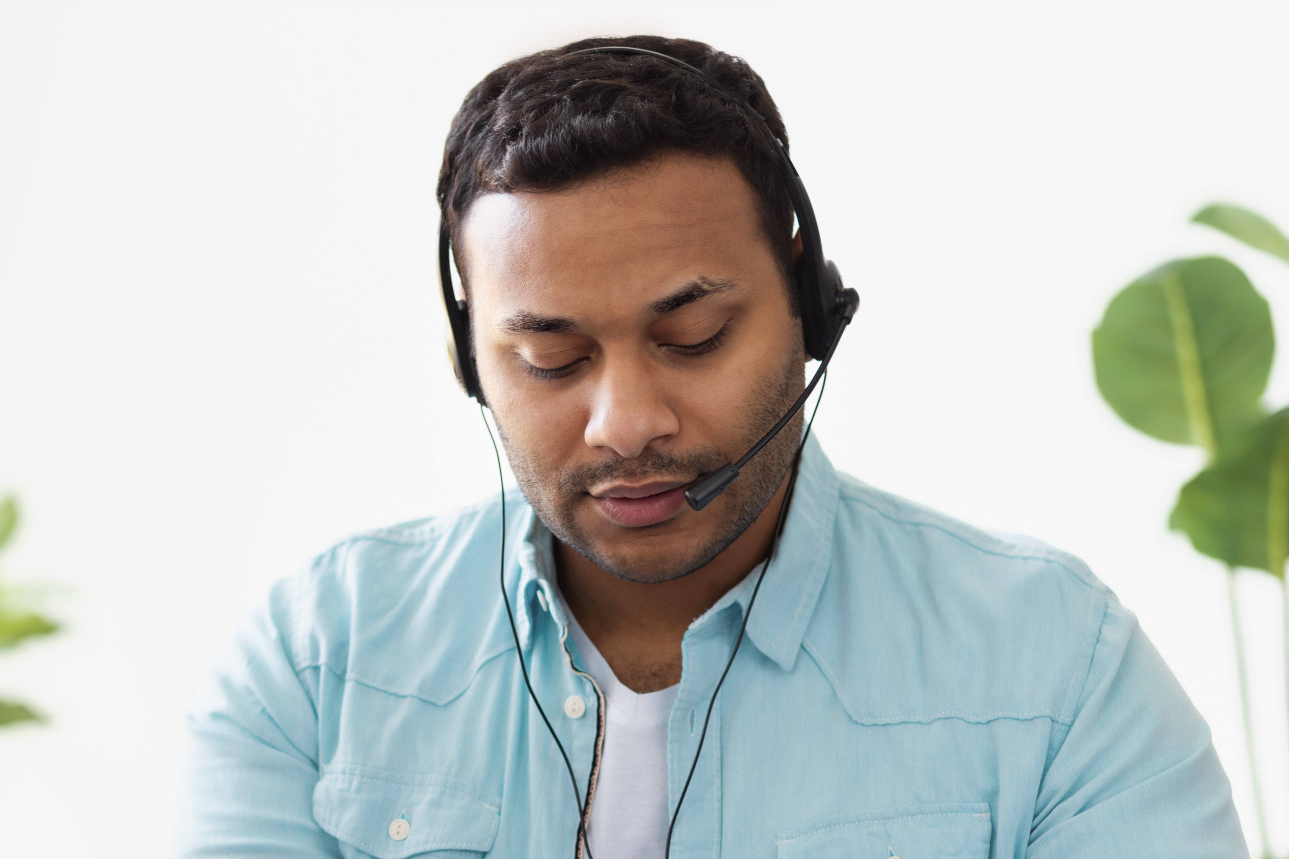 Man at call centre wearing headset 